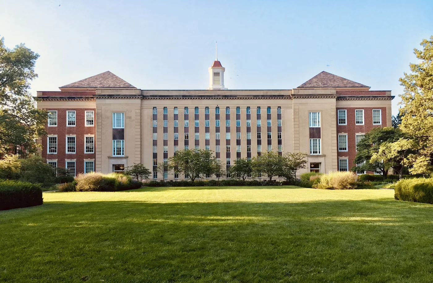 University campus buildings and lawns under blue sky